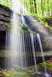 sunbeam over the waterfall in the forest