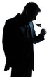 silhouette man portrait smelling red wine glass