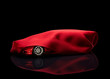 new car hidden under red cover new car hidden under red cover