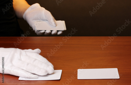 Photo: Cards and hand on brown background Cards and hand on brown background
