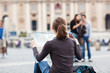 Pretty young female tourist studying a map at St. Peter's square