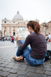 Pretty young female tourist studying a map at St. Peter's square