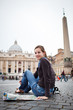 Pretty young female tourist studying a map at St. Peter's square