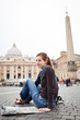 Pretty young female tourist studying a map at St. Peter's square