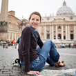 Photo: Pretty young female tourist studying a map at St. Peter's square Pretty young female tourist studying a map at St. Peter's square