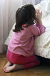 A young baby girl saying her bedtime prayers