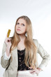 Photo: Happy young woman holding a golden credit card Happy young woman holding a golden credit card