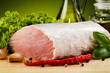 Raw pork on cutting board and vegetables