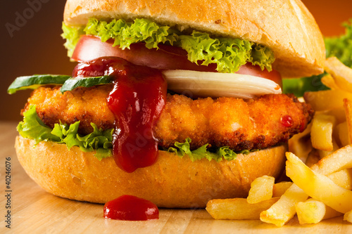 Photo: Big hamburger, French fries and vegetables Big hamburger, French fries and vegetables