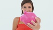 Girl saving cash in her piggy-bank