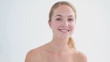 Blonde woman plucking her eyebrows