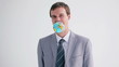 Happy executive holding a globe with his mouth