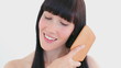 Peaceful woman brushing her hair