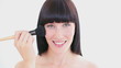 Happy brunette woman using a powder brush
