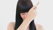 Smiling brunette using a comb