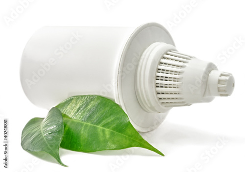 Photo: Water Filter cartridge Bio with green leaf on white background Water Filter cartridge Bio with green leaf on white background