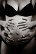 hands on pregnant woman's abdomen