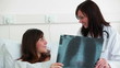 Smiling doctor talking to a patient