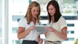 Two females workers using an eBook