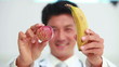 Doctor showing banana and apple