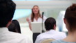 Blonde woman giving a conference