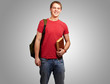 portrait of young student holding book and carrying backpack ove