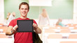 portrait of young man holding a digital tablet at classroom