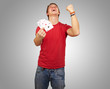 portrait of young man doing a winner gesture playing poker over portrait of young man doing a winner gesture playing poker over