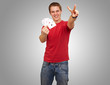 portrait of young man doing a victory gesture playing poker over portrait of young man doing a victory gesture playing poker over