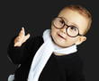 portrait of adorable kid gesturing doubt against a black backgro portrait of adorable kid gesturing doubt against a black backgro