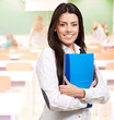 portrait of young woman holding notebook on classroom portrait of young woman holding notebook on classroom