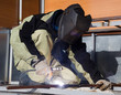 Photo: Welder in a special suit while working Welder in a special suit while working