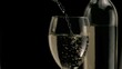 White wine being poured in super slow motion in a glass