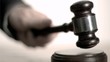 Man's hand striking in super slow motion a gavel 