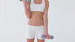 Woman using blue dumbbells