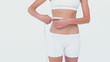 Woman using a tape on her waist