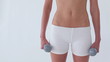 Standing woman holding dumbbells 