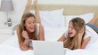 Video: Smiling women looking together at a laptop Smiling women looking together at a laptop