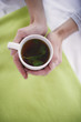 Woman holding cup of herbal tea, overhead view