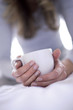Woman holding cup of tea, close-up