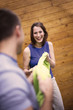 Young couple playing with green cloth, smiling