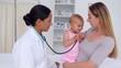 Doctor talking to a woman holding a baby