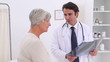 Doctor holding a chest x-ray and gives a handshake to a patient
