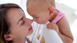 Baby girl kissing her mother