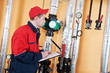 heating engineer repairman in boiler room