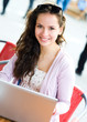 Photo: Young woman with notebook in cafe Young woman with notebook in cafe