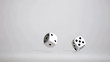 Pair of white dice in super slow motion bouncing
