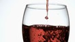 Red wine in super slow motion dripping in a glass