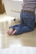 Boy kneeling by sofa, low section