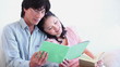 Man reading a booklet with a woman